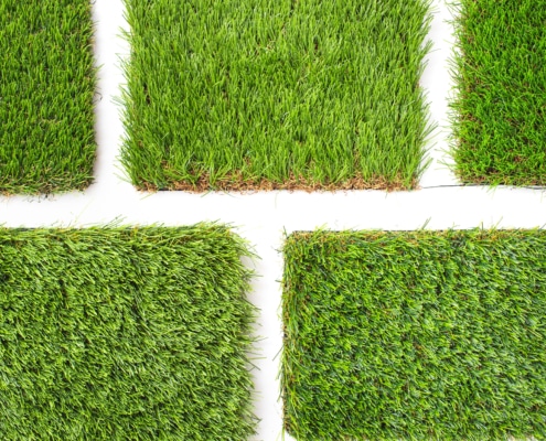 Detail of types of artificial grass in a sample book.